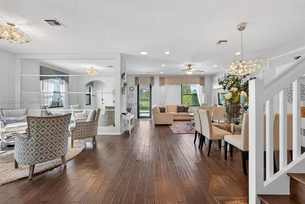 a living room with furniture and a wooden floor