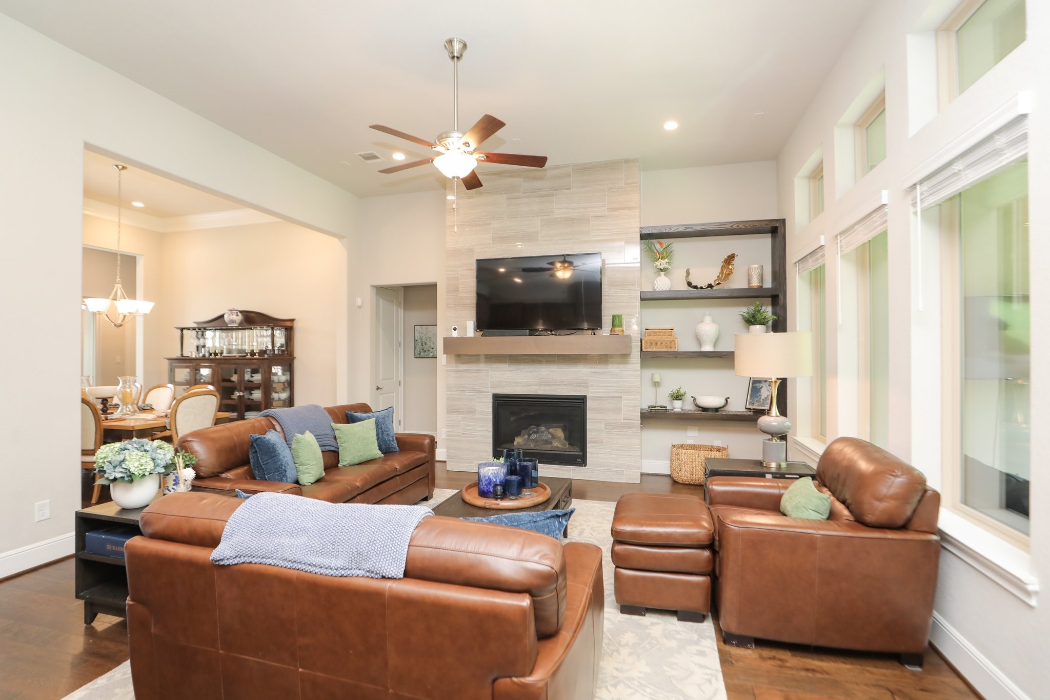 8511 Tynan Ridge Drive Magnolia, TX 77354 - Photo 13 of 50 a living room with furniture a fireplace and a flat screen tv