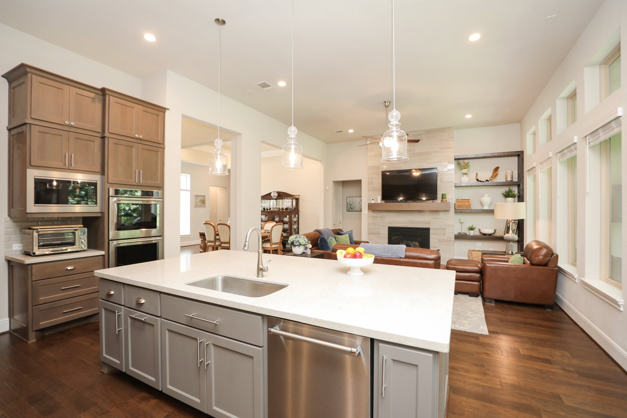 8511 Tynan Ridge Drive Magnolia, TX 77354 - Photo 15 of 50 a room with stainless steel appliances kitchen island granite countertop a sink dishwasher stove and oven with wooden floor