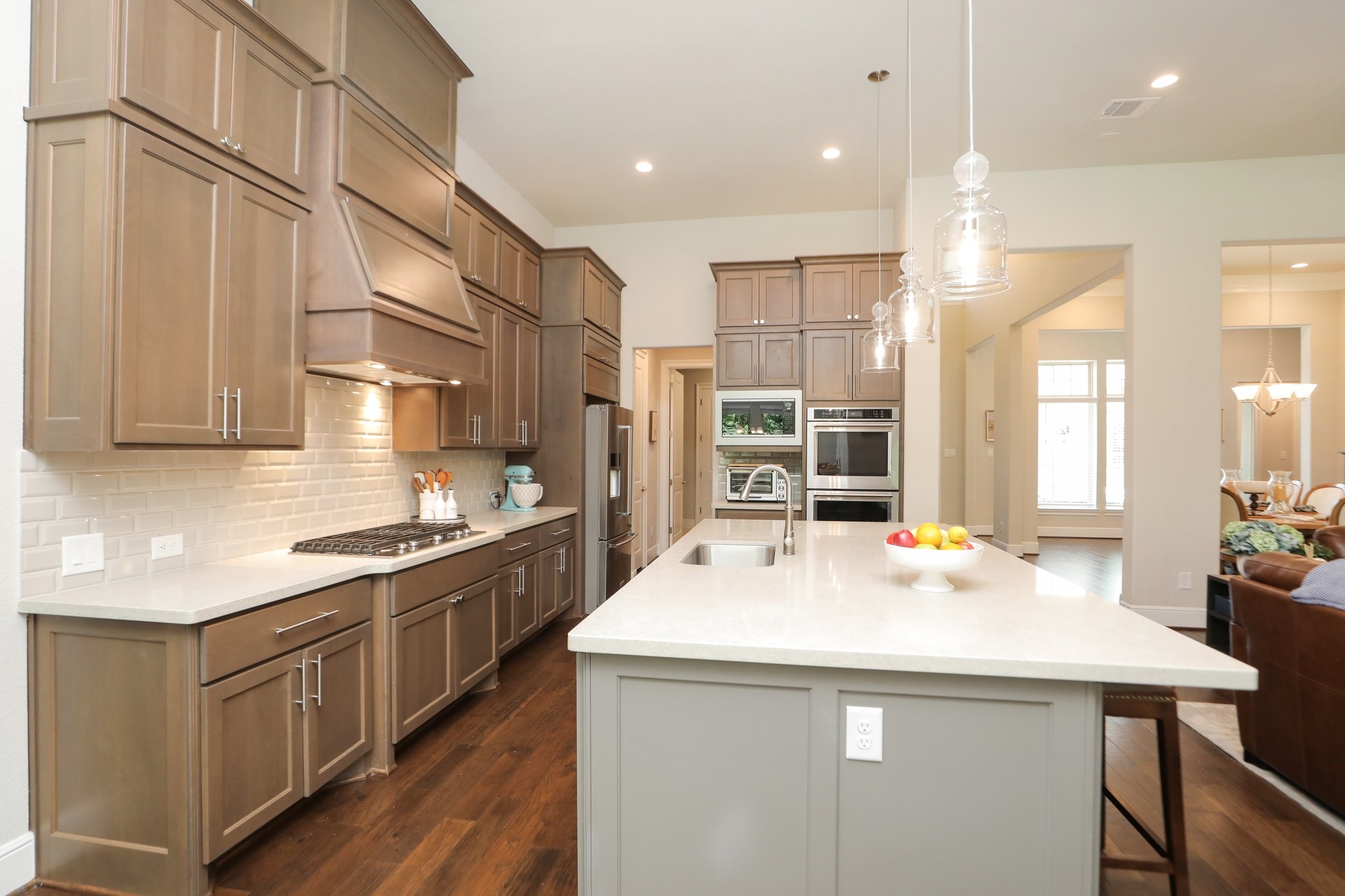 8511 Tynan Ridge Drive Magnolia, TX 77354 - Photo 16 of 50 Notice the stylish hardware, 5-burner gas cooktop, double ovens, and built-in microwave—this kitchen is as functional as it is beautiful. A large walk-in pantry and a thoughtfully designed appliance closet provide smart, organized storage solutions.
