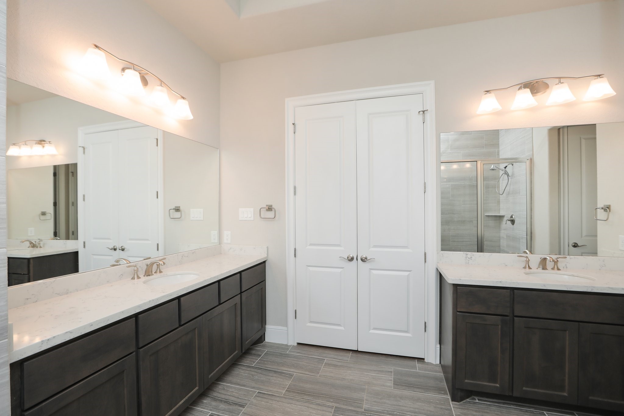 8511 Tynan Ridge Drive Magnolia, TX 77354 - Photo 23 of 50 a bathroom with double vanity sinks and a mirror