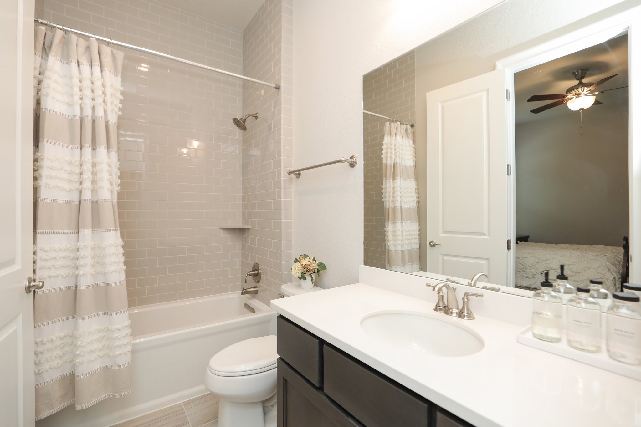 8511 Tynan Ridge Drive Magnolia, TX 77354 - Photo 30 of 50 a bathroom with a granite countertop sink a toilet and shower