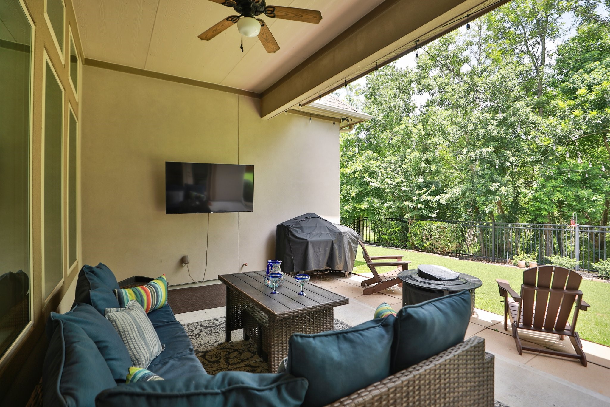 8511 Tynan Ridge Drive Magnolia, TX 77354 - Photo 38 of 50 a outdoor living space with furniture and a flat screen tv