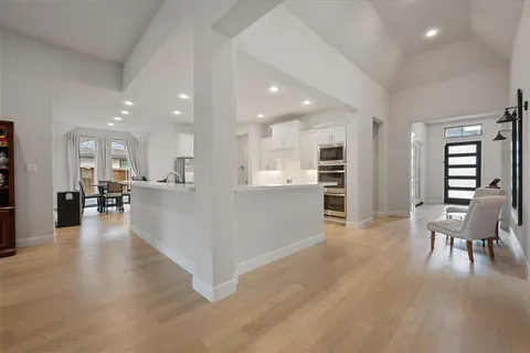 a living room with furniture and a glass door
