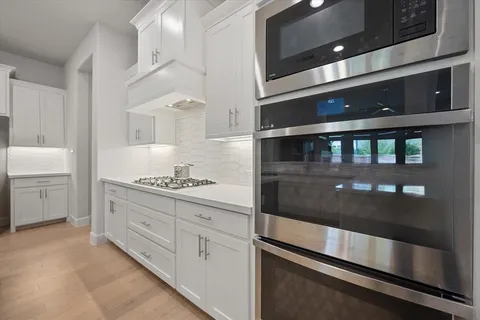 a kitchen with refrigerator and cabinets