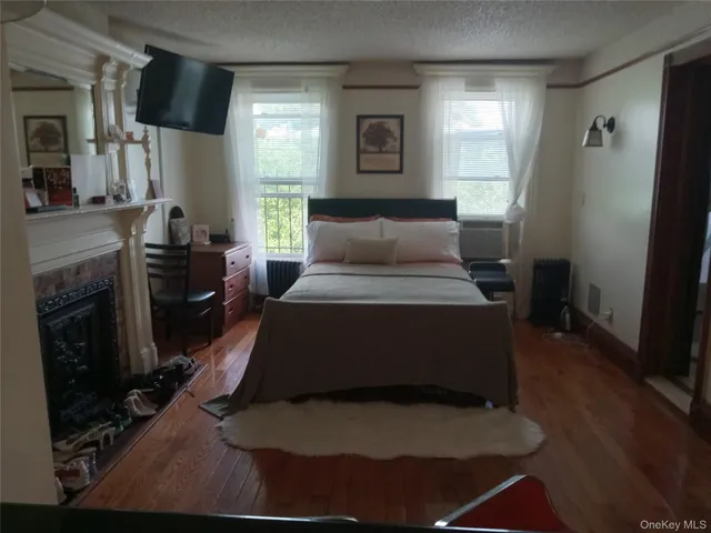 a bedroom with a bed and a fireplace