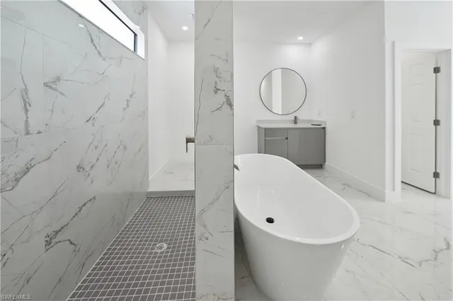 an empty room with ceiling fan and windows