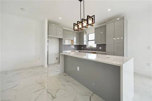a open kitchen with cabinets and stainless steel appliances