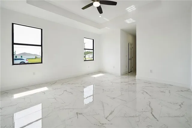 a living room with granite countertop furniture a ceiling fan and a window