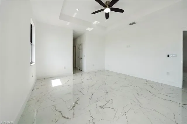 a view of kitchen with windows and refrigerator