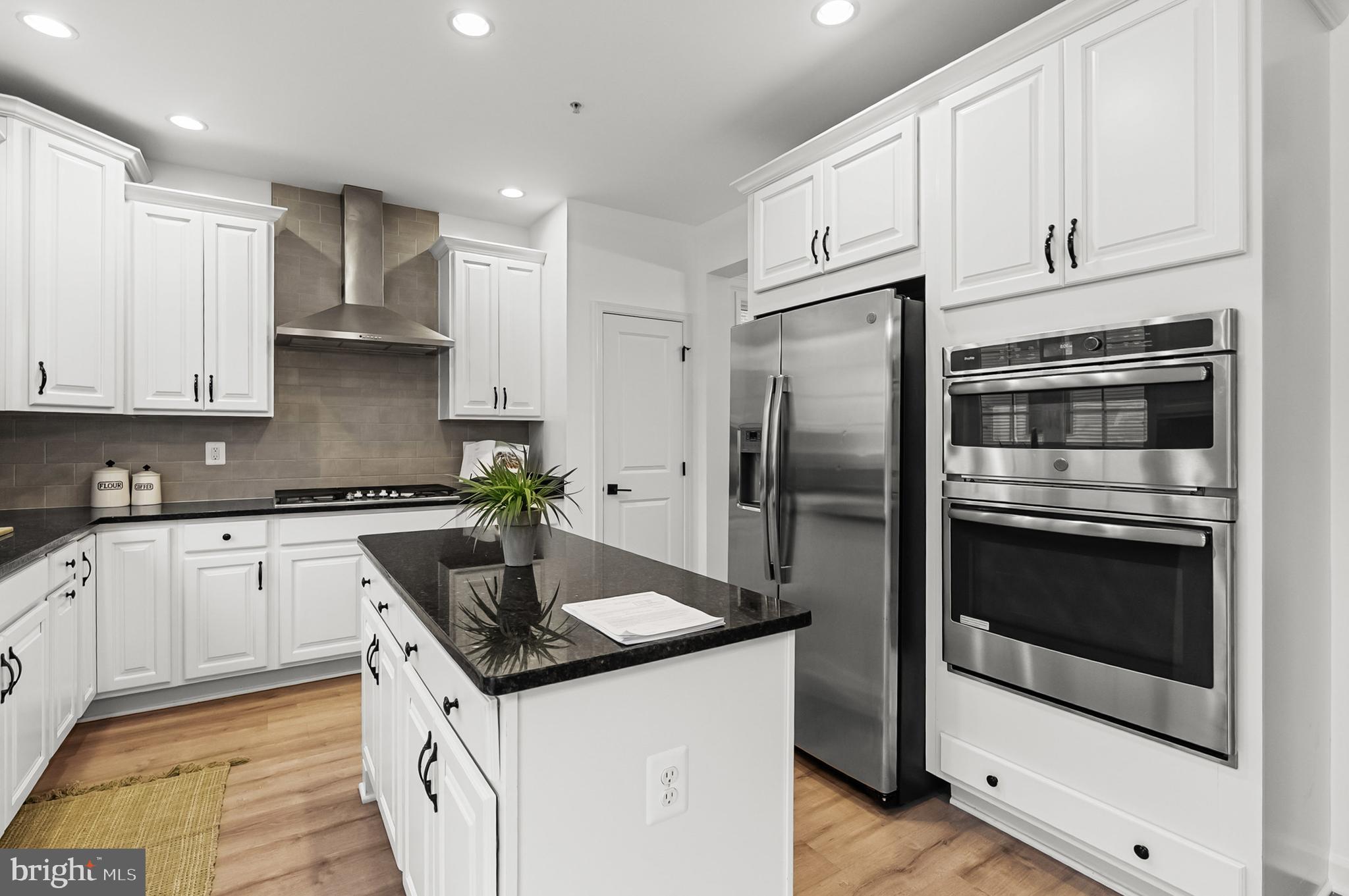 4603 Thoroughbred Drive Upper Marlboro, MD 20772 - Photo 25 of 64 a kitchen with granite countertop stainless steel appliances and white cabinets
