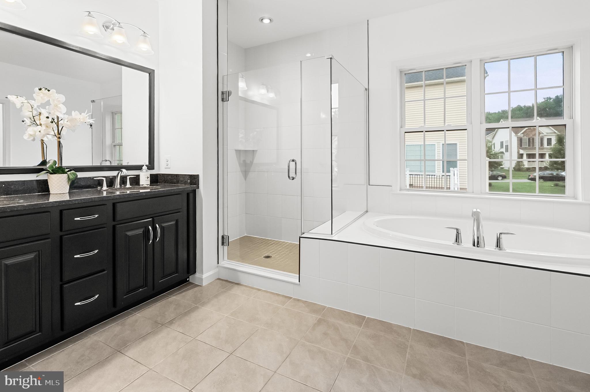 4603 Thoroughbred Drive Upper Marlboro, MD 20772 - Photo 38 of 64 a spacious bathroom with a tub sink shower and mirror