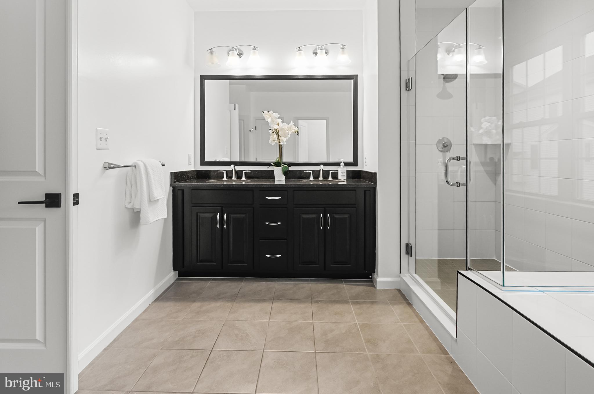 4603 Thoroughbred Drive Upper Marlboro, MD 20772 - Photo 39 of 64 a bathroom with a granite countertop sink a mirror and a bathtub