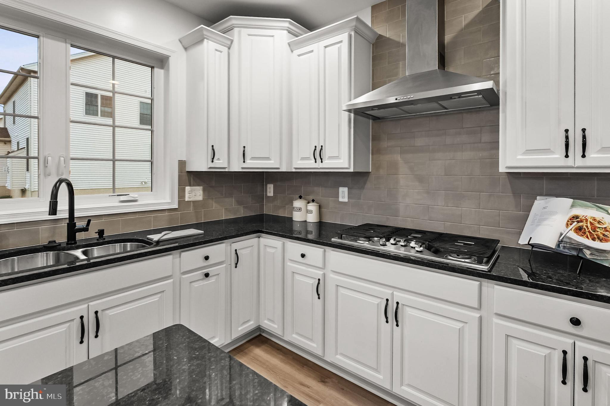 4603 Thoroughbred Drive Upper Marlboro, MD 20772 - Photo 58 of 64 a kitchen with granite countertop white cabinets and a stove