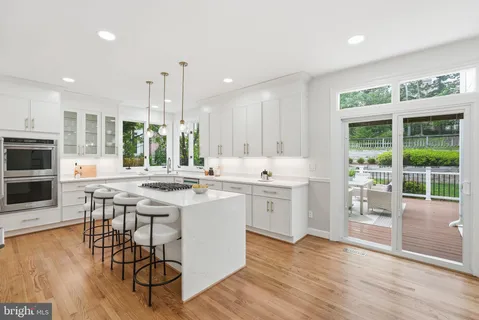 a kitchen with a sink cabinets and wooden floor