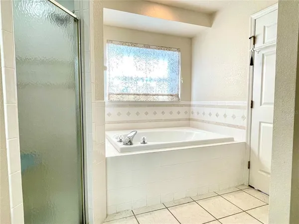 a bath tub sitting next to a window