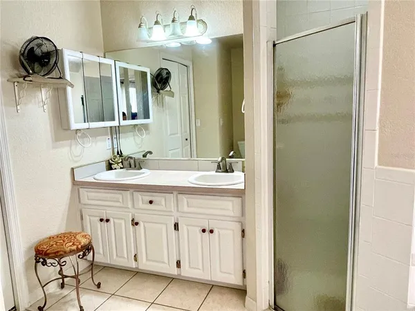 a bathroom with a double vanity sink and a mirror