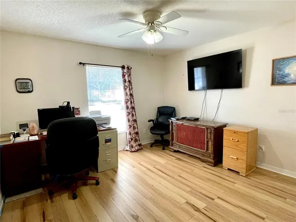 a view of a workspace with furniture and a flat screen tv