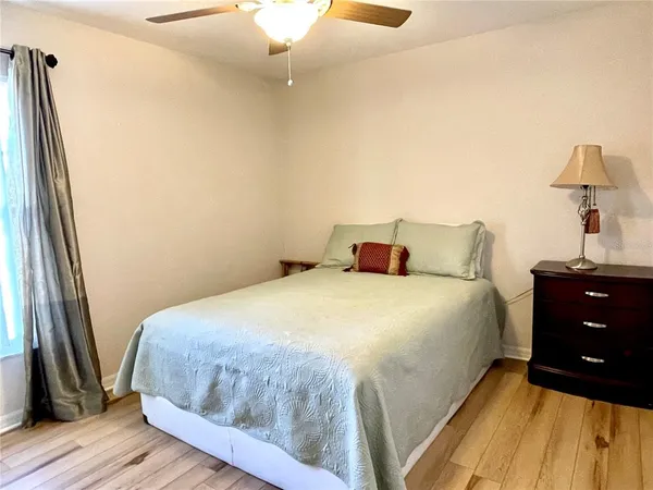 a bedroom with a bed and wooden floor