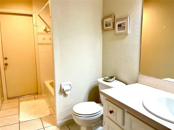 a white toilet sitting next to a bathroom sink