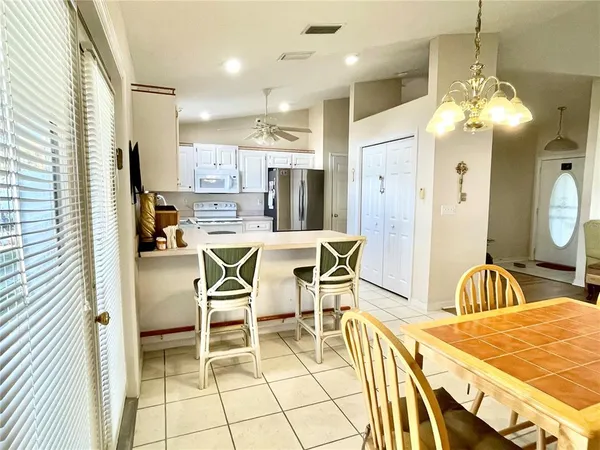 a view of a dining room with furniture and a chandelier