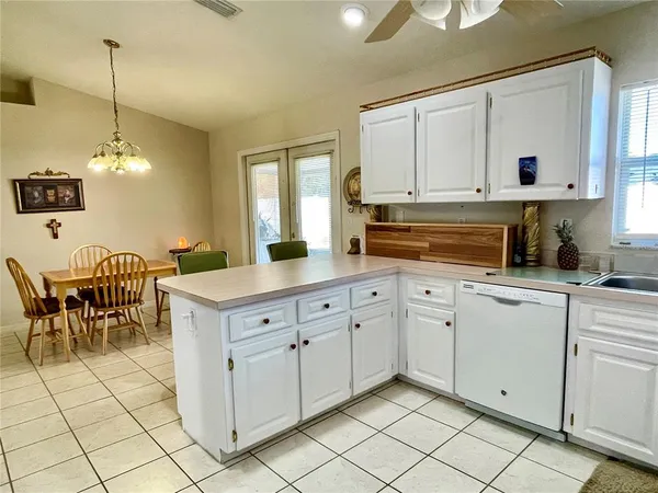 a kitchen with cabinets and chairs