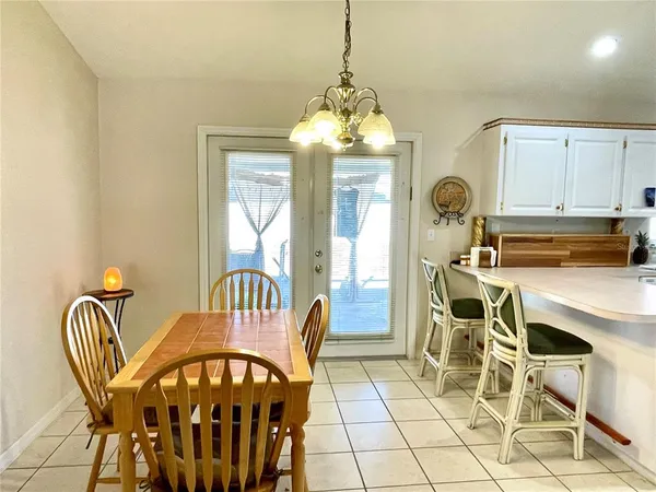 a view of a dining room with furniture and chandelier