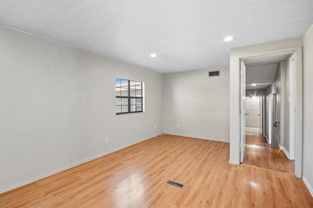 413 Charnel Street Clyde, TX 79510 - Photo 13 of 31 wooden floor in an empty room with a window