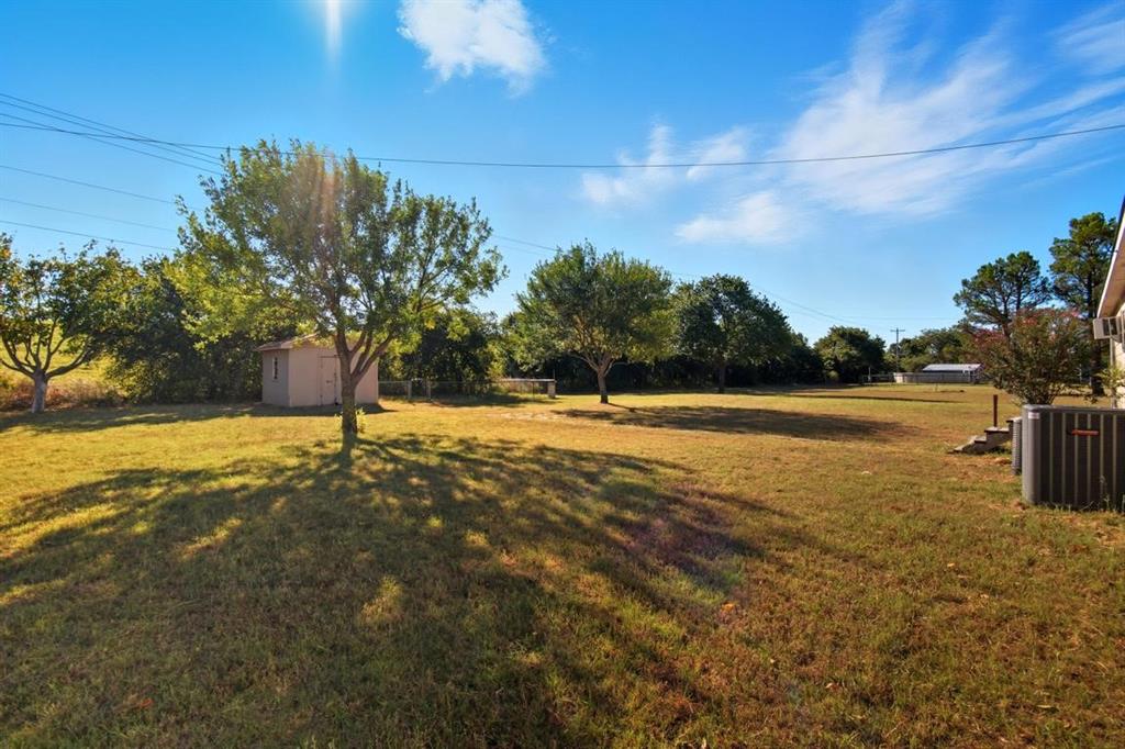 413 Charnel Street Clyde, TX 79510 - Photo 28 of 31 a view of yard with swimming pool and trees