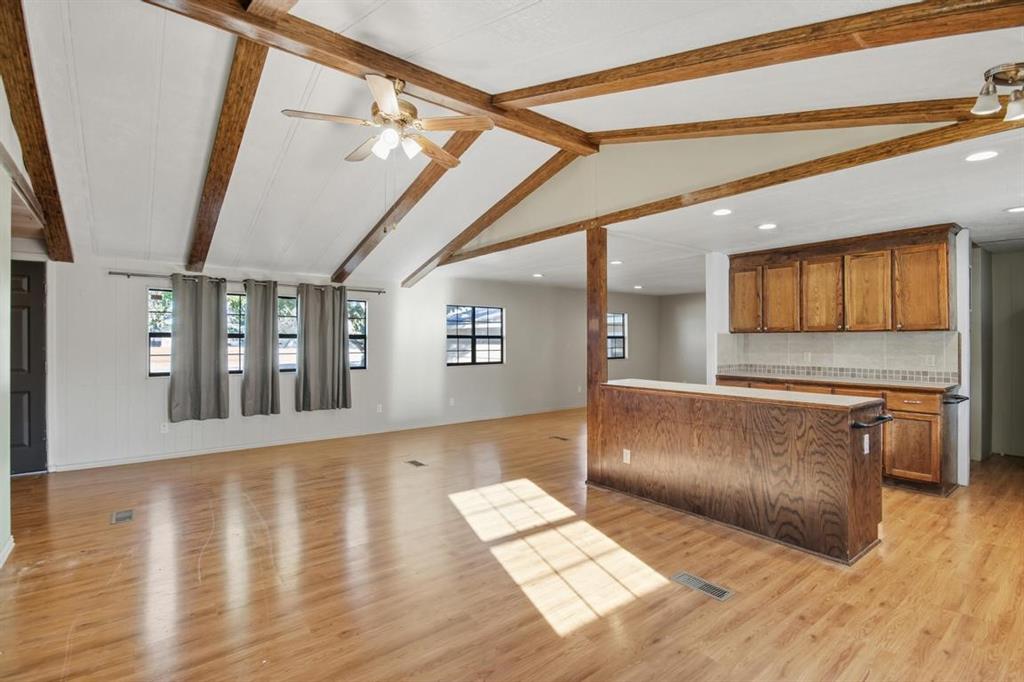 413 Charnel Street Clyde, TX 79510 - Photo 7 of 31 a living room with stainless steel appliances wooden floors and couches