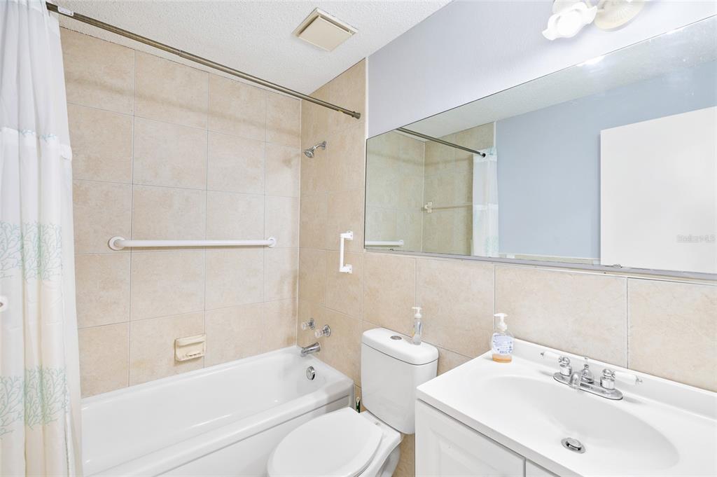 4930 Hazner Street New Port Richey, FL 34652 - Photo 13 of 22 a bathroom with a sink toilet and shower