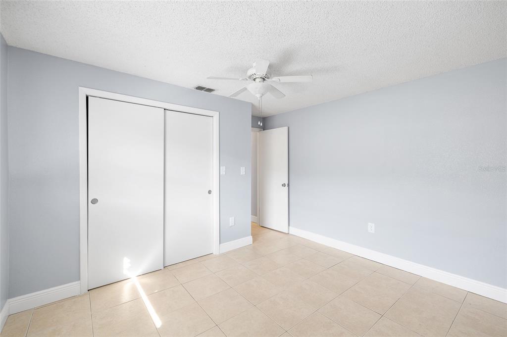 4930 Hazner Street New Port Richey, FL 34652 - Photo 15 of 22 an empty room with a ceiling fan and a window