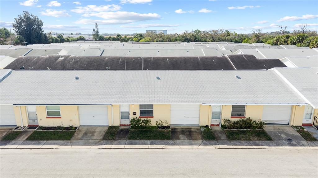 4930 Hazner Street New Port Richey, FL 34652 - Photo 3 of 22 a view of a white house with a yard and a garage