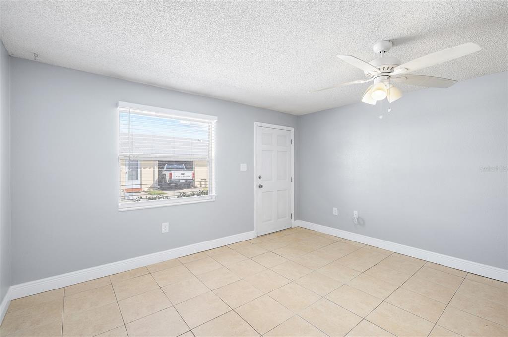 4930 Hazner Street New Port Richey, FL 34652 - Photo 4 of 22 an empty room with windows and fan