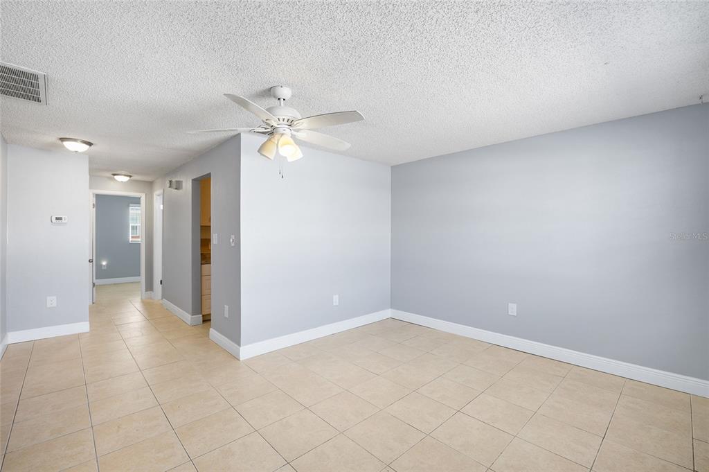 4930 Hazner Street New Port Richey, FL 34652 - Photo 6 of 22 wooden floor in an empty room and a chandelier fan