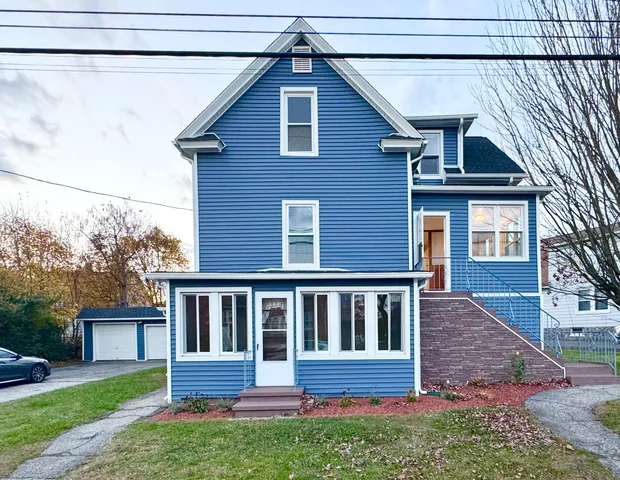 a view of front of house with a yard