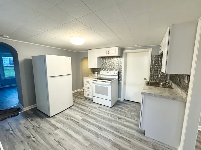 a kitchen with a refrigerator sink and stove