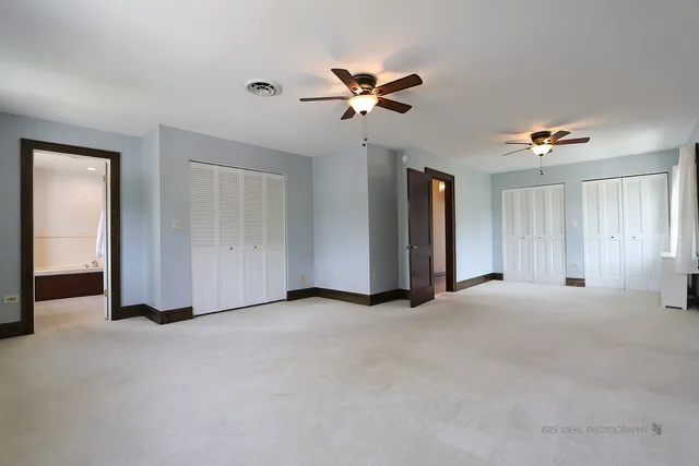 a view of empty room with ceiling fan
