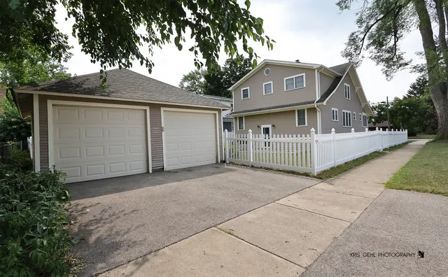 a view of house with a garden and pathway
