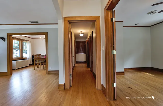 a view of a hallway with wooden floor windows and livingroom