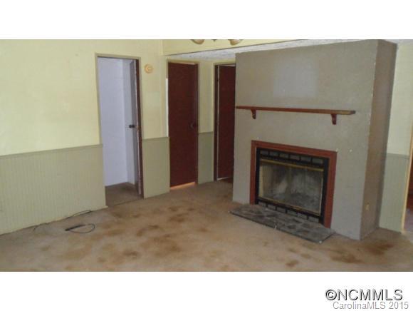263 Inman Branch Road Waynesville, NC 28786 - Photo 5 of 10 a open living room with a fireplace