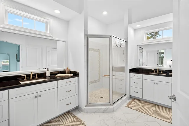 a spacious bathroom with double sink and a mirror