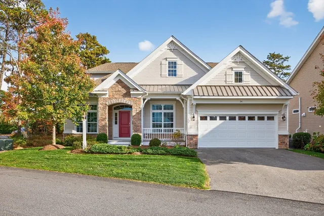 a front view of a house with a garden and plants