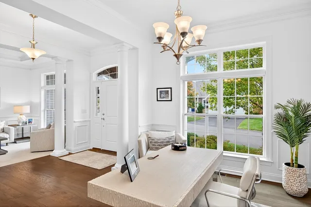 a view of a dining room with furniture wooden floor and chandelier