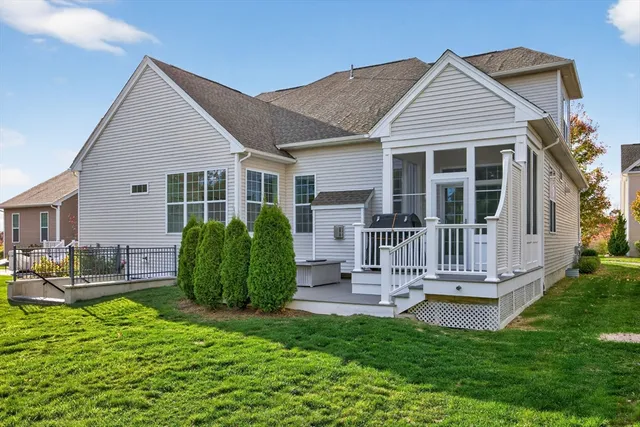 a view of a house with backyard and sitting area