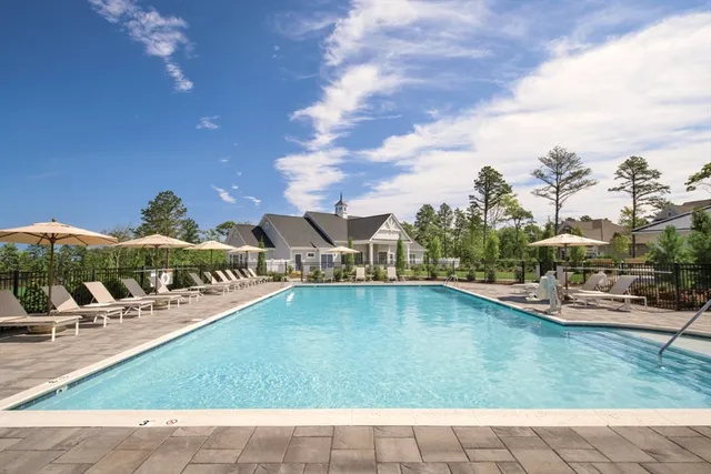a view of a swimming pool with outdoor seating