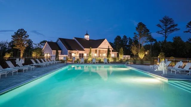 an outdoor space with swimming pool and furniture