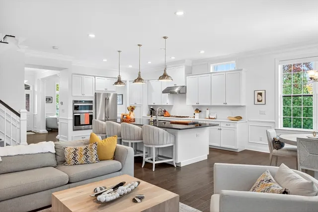 a living room with kitchen island furniture and a kitchen view