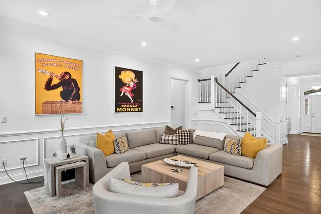 a living room with furniture and wooden floor