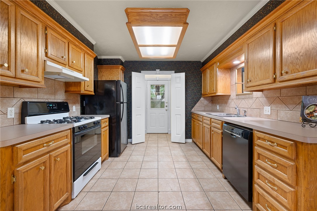 2287 North Earl Rudder Freeway Bryan, TX 77803 - Photo 2 of 32 a kitchen with stainless steel appliances granite countertop a stove a sink and a refrigerator